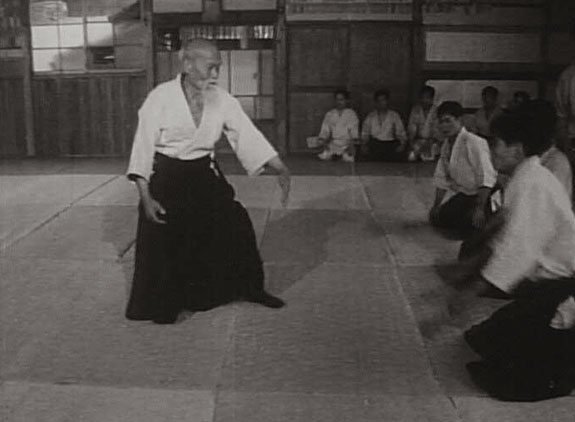 Aikido Founder Morihei Ueshiba taking the initiative and directing the attention of uke prior to physical contact.