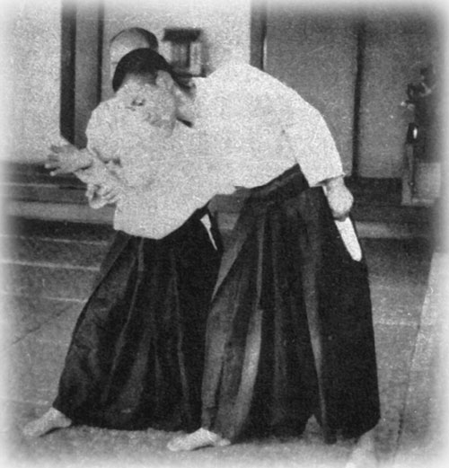Aikido Founder Morihei Ueshiba executing a setup to iriminage that is very different and does not reveal the vulnerabilities mentioned in this analysis.